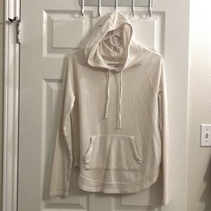Cream colored hoodie. Thin sweater material, "pouch" pocket in front